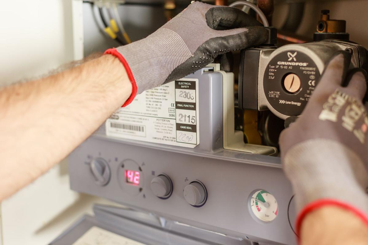 Technician checking an HVAC unit during maintenance